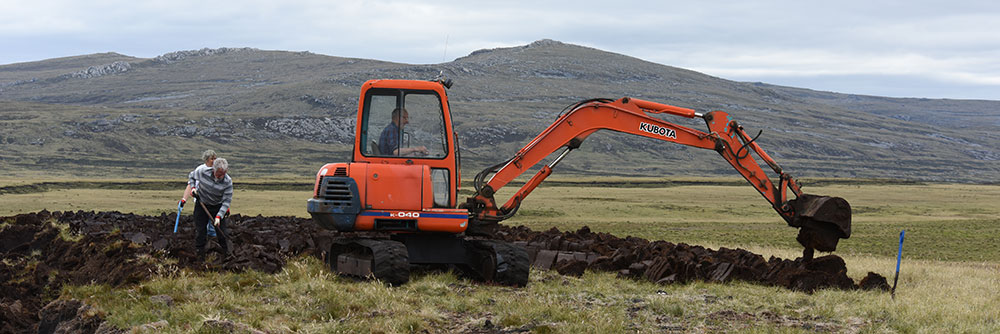 Peat, mechanical digger cutting peat